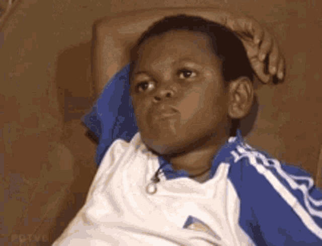 animated gif of a child sitting on a couch in defeat as the camera slowly moves back to reveal his surroundings